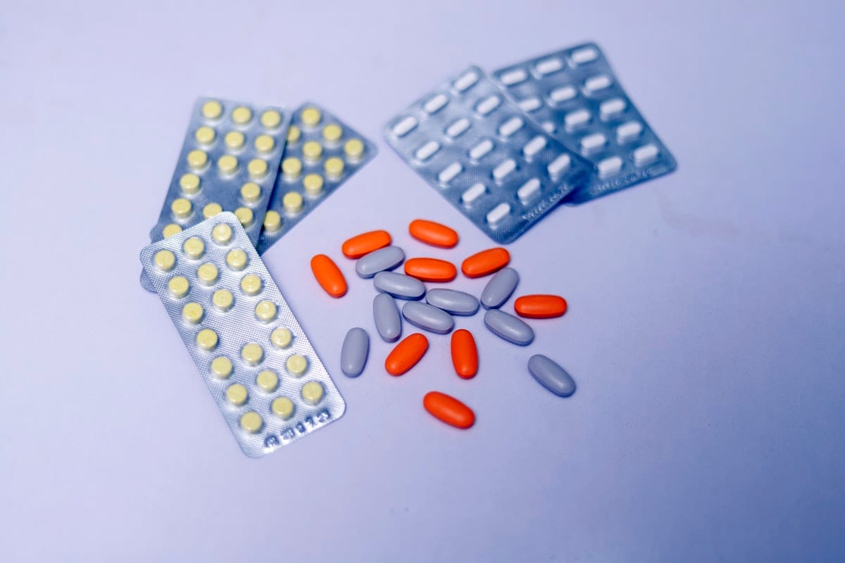 Plain white tablets and capsules on a table