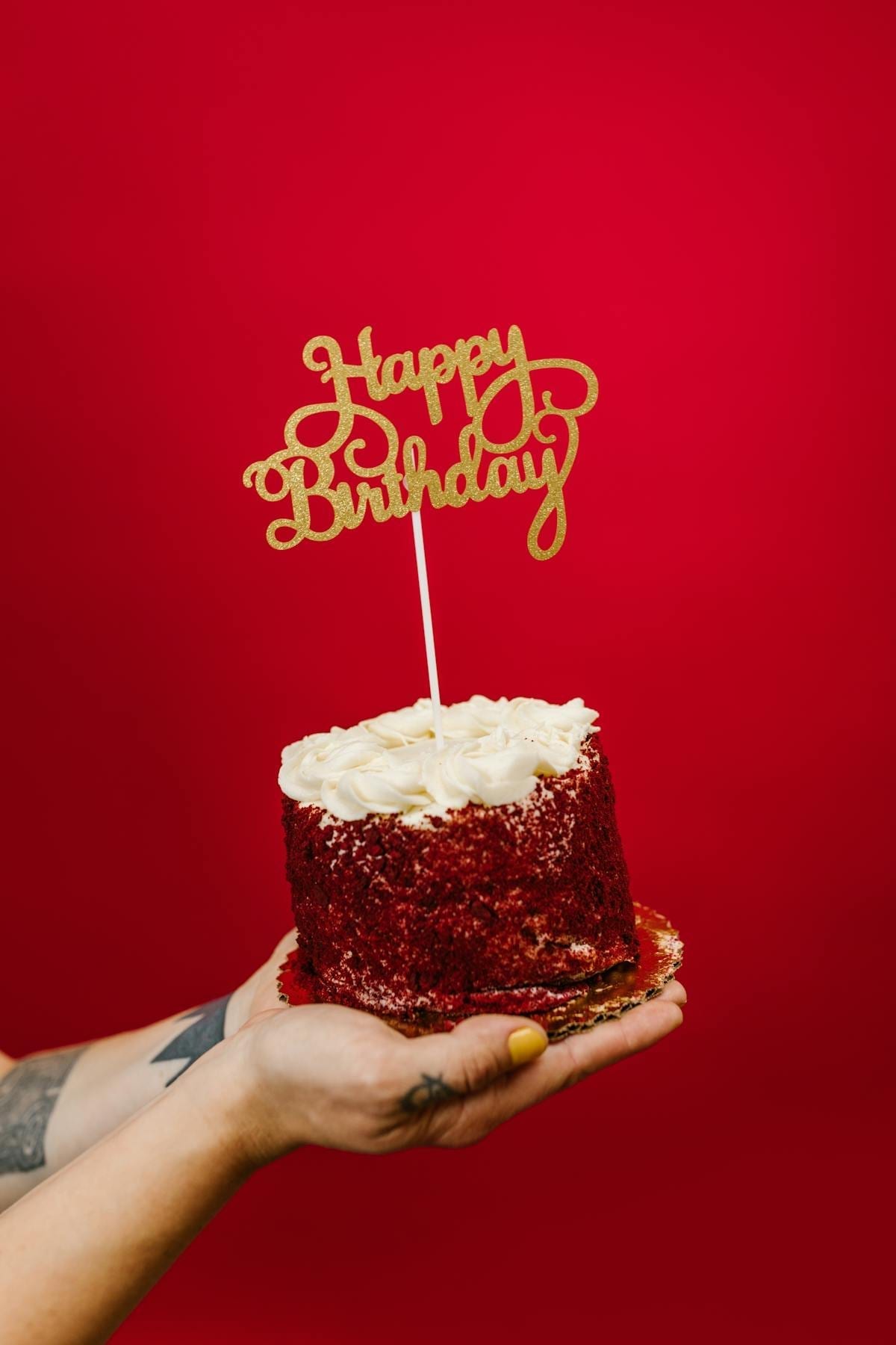 Close-up of a red velvet birthday cake with a Happy Birthday topper