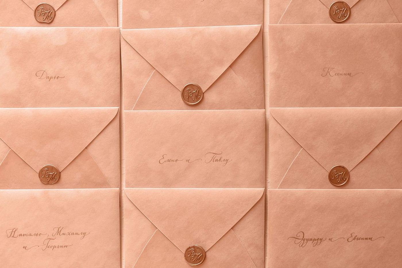 Rows of peach coloured envelopes sealed with wax and addressed in handwriting